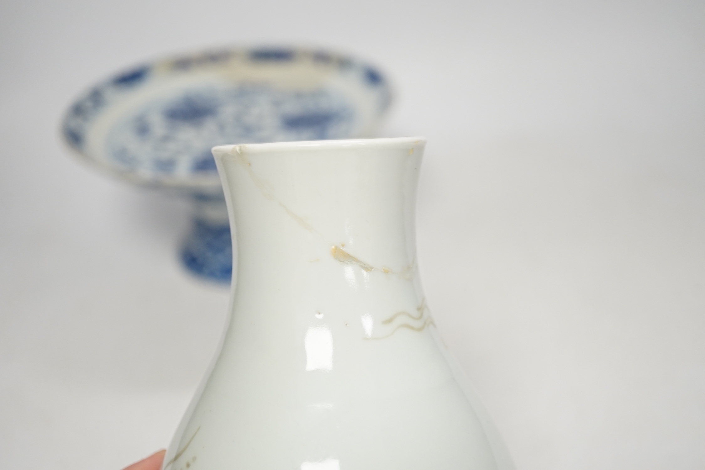 A Chinese underglaze copper red ‘herder and goats’ vase, Kangxi six character mark but Republic period and a Chinese blue and white lotus stem dish, six character Guangxu mark and period, both damaged